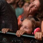 crowd at a concert with young girl in the front