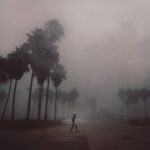 surfer walking on road