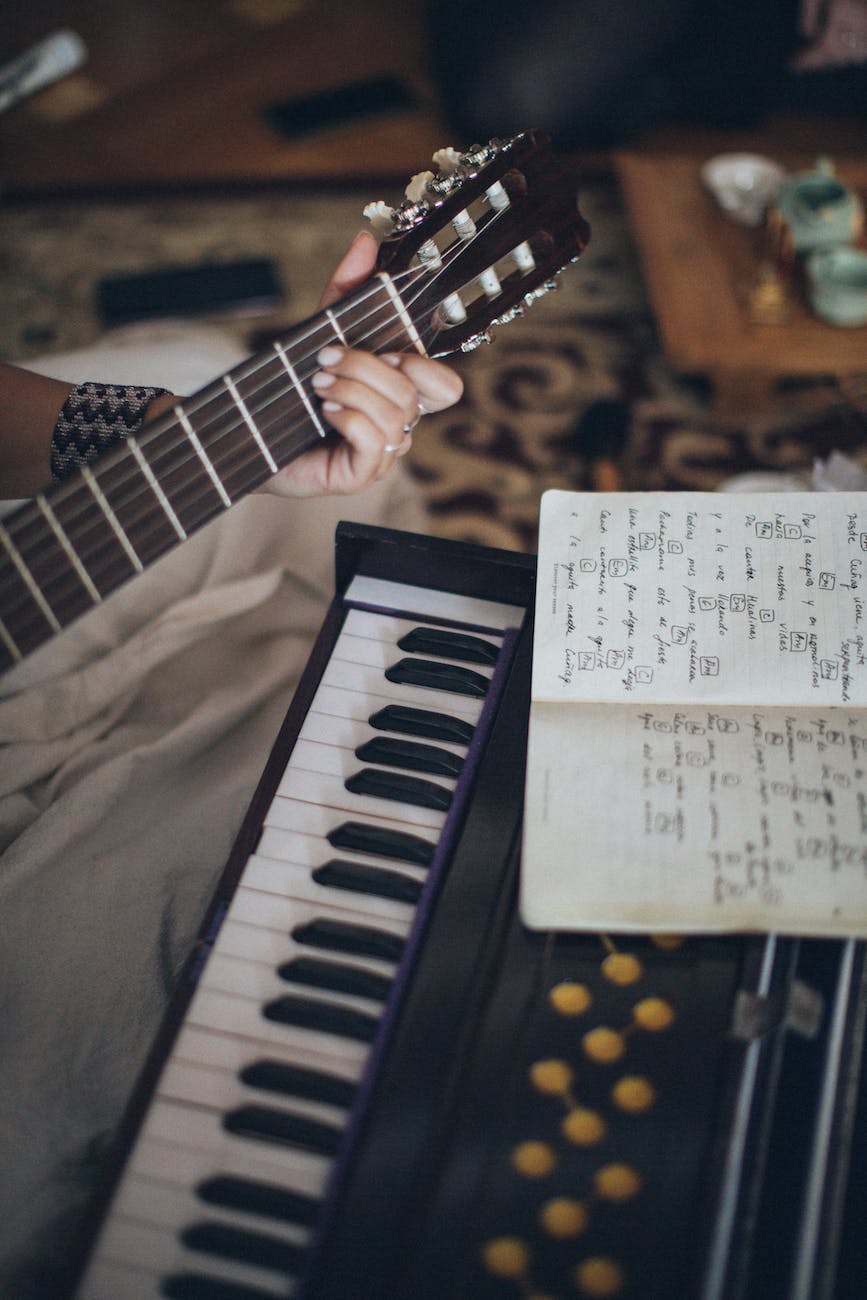 person playing guitar with musical notes