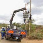 Image of Kenya Power personnel fixing a transformer.