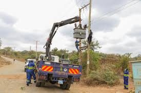 Image of Kenya Power personnel fixing a transformer.