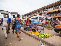 An image of hawkers selling items behind the road.